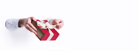 Man holding a gift box on white background.の写真素材