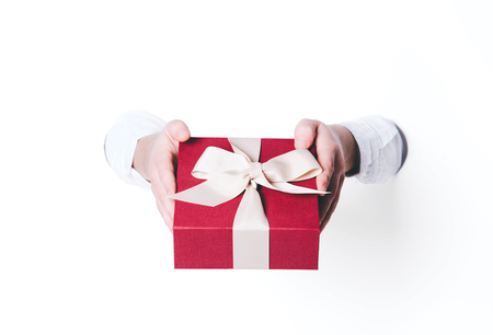 Man holding a gift box on white background.の写真素材