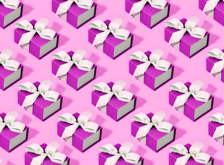 Pattern made of pink gift boxes on pastel background.の写真素材