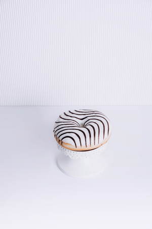 Striped donut on a white background. Stylish minimal conceptの写真素材