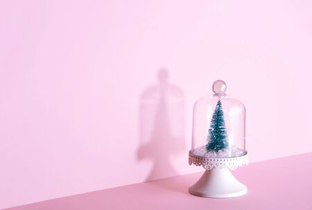 Creative Christmas design on pink pastel color background with Christmas tree. Xmas and holiday concept.の写真素材