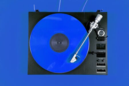 Colored vinyl record on a red background with copy space. Top view.の写真素材