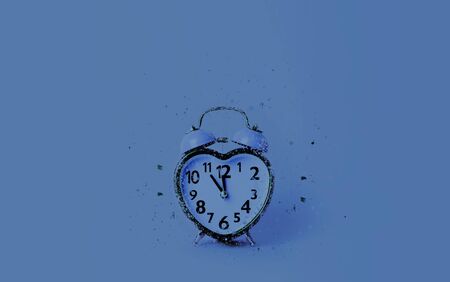 Heart shaped clock on blue background. Valentines day and love and duration concept.の写真素材