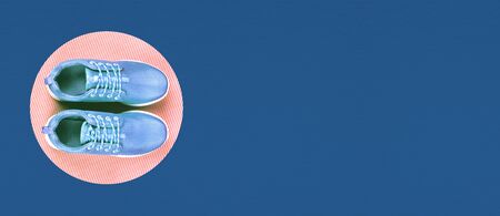 Blue sneakers on classic blue background. Trendy color 2020. Top view, Fashion style.の写真素材
