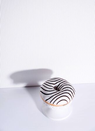 Striped donuts on a white background. Stylish minimal conceptの写真素材