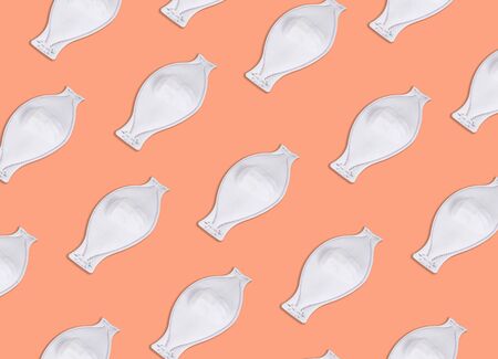 A simple fabric disposable medical mask on orange background.の写真素材