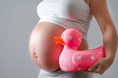 pregnant woman with a big toy duckの写真素材
