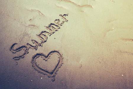 text in the sand on the beach during the summer holidaysの写真素材