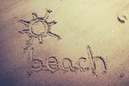 text handwritten on the beach during the holidaysの写真素材