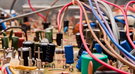 Close up of a circuit board with electrical components and colored cordsの写真素材