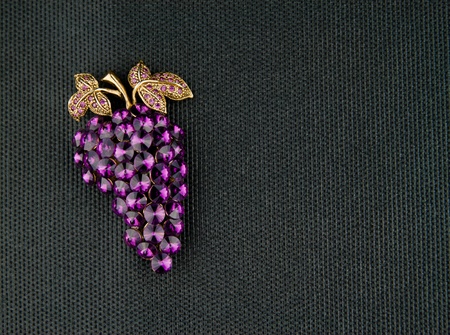 Purple brooch in the shape of a grape clusterの写真素材
