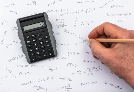Person doing calculations on paper and calculator