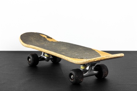 Old skateboard on black and white backgroundの写真素材
