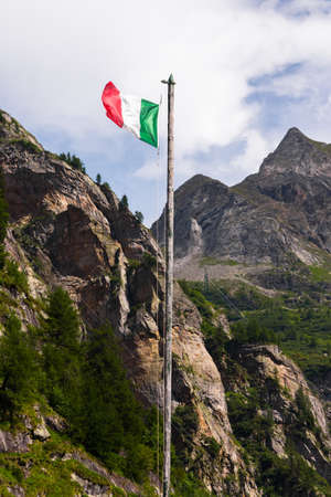 Italian flag on a grungy pole at the Toce waterfallの写真素材