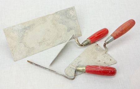 Dirty masonry tools on a light clean surfaceの写真素材