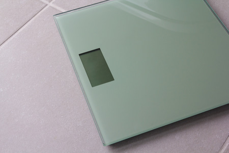 Bath room scale on a tile floor