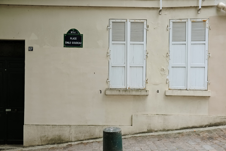 Parisien town house facade with closed shutters made of woodの写真素材