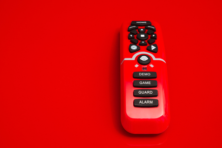 remote control with black rubber buttons with the text demo, game, guard and alarm printed on