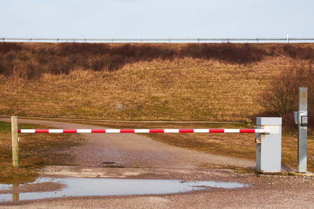 Closed road barrier keeping traffic off an isolated dirt road