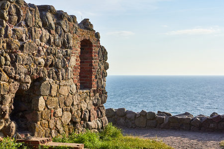 Part of a boulder wall at Hammershus ancient castle ruin on bornholm, denmark, with the Baltic Sea in the backgroundの写真素材
