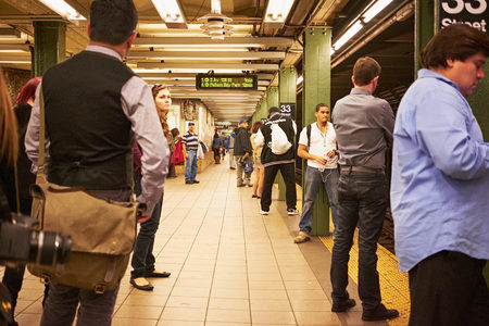 NEW YORK CITY - OCTOBER 9, 2014: People waiting for the subway train on the platform of the 33...