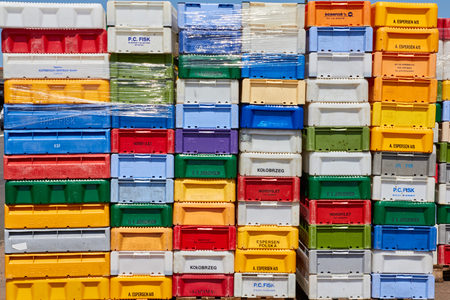 NEXØ, DENMARK - JULY 13, 2013: vivid colored fish crates stacked up on the habour of Nexø, Bornholm, creating a nice backgroundの写真素材