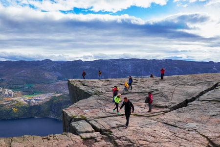 PULPIT ROCK, NORWAY - OCTOBER 12, 2015: People walking, hiking and standing on the Pulpit Rock outcrop, 600 meters above the Lysefjordのeditorial素材