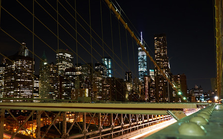 NEW YORK CITY - OCTOBER 18, 2014: Financial district skyline illuminated at night, seen from a night walk on Brooklyn Bridgeのeditorial素材