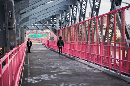 NEW YORK CITY - OCTOBER 16, 2014: an orthodox jew and a man in leather jacket walking the Williamsburg Bridge on Brooklyn sideのeditorial素材
