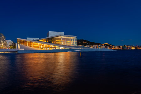Oslo / Norway - September 15th 2019: The waterfront in Oslo with Oslo Opera House seen in the blue hourのeditorial素材
