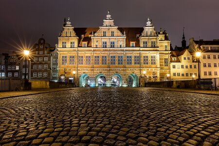Night photo of the Green Gate at the old town in Gdansk at dusk, Polandの写真素材