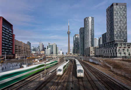 Three commuter trains passing each other in downtown Torontoのeditorial素材