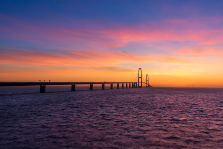 The Great Belt bridge in Denmark during a very colorful sunsetの写真素材