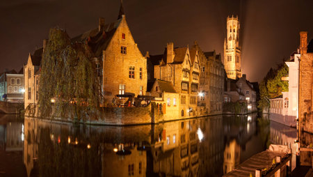 Reflections in a canal in Bruges, Belgiumの写真素材