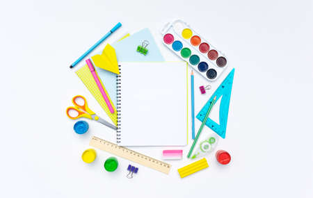 School notebook on a spring against the background of multi-colored office stationery and accessories. ... A mockup of a student's notebook surrounded by colorful stationery.の写真素材