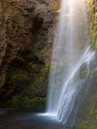 A beautiful waterfall in Iceland in the sunlight