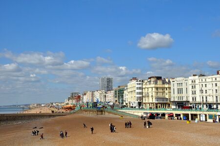 Brighton, United Kingdom - April 16, 2012: Tourists on the beach enjoying a Spring day at Brighton on the south coast of England.のeditorial素材