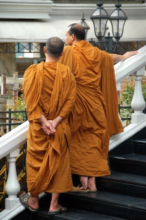 Bangkok, Thailand - April 13, 2008: Young Buddhist Monks in their traditional orange robes view the Songkran (Thailand New Year) festivities in the streets of Bangkok.のeditorial素材