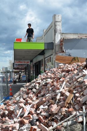 29 September 2010 - Christchurch, New Zealand - September 29, 2010: A young  businessman views the devastation of a shop in Riccarton Road - one of the hardest hit areas in the earthquake on September 29, 2010 in Christchurch.のeditorial素材