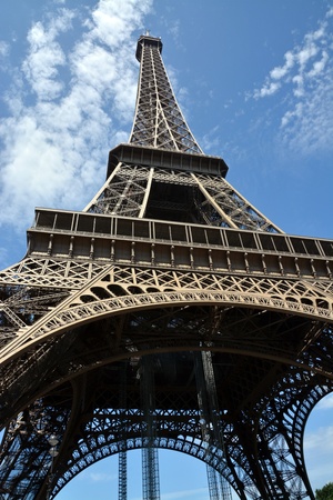 Detailed view of the structure of the Eiffel Tower from underneath on a hot summer day 