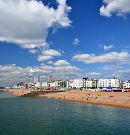 Brighton, United Kingdom - April 16, 2012: Vertical Panorama view of tourists on the beach enjoying a Spring day at the historic holiday town of Brighton on the south coast of England. Plenty of copy space available.のeditorial素材
