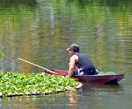 Hanoi Vietnam  April 13 2015: Fisherman in a boat on the West Lake in Hanoi.のeditorial素材