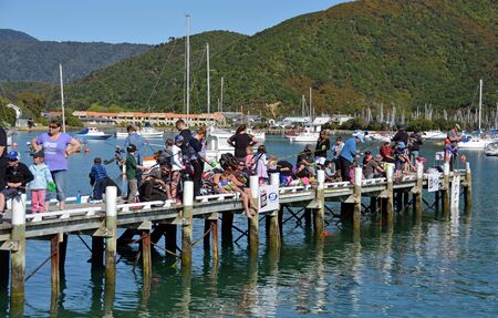 Picton, New Zealand - October 09, 2015: Dozens of keen young anglers compete in the annual  Childrens' Fishing competition held on the Waikawa Bay Jetty, Picton New Zealand.のeditorial素材