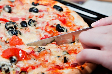 The pizza with tomato, olive and cheese の写真素材