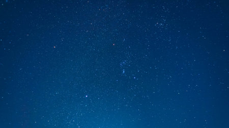 Night starry sky with many stars. Long exposure photograph with grain