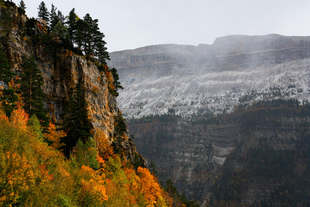Golden Autumn and snowing in Pyrenees national parkの写真素材