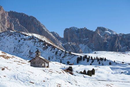 Old church in Dolomites Alps in winter on a sunny day, Italyの写真素材