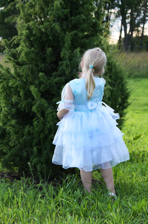 Little girl near the juniperの写真素材