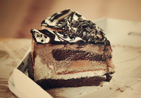 A piece of sweet cake with cream and chocolate decor