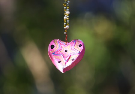 Decorative handmade heart on summer nature backgroundの写真素材